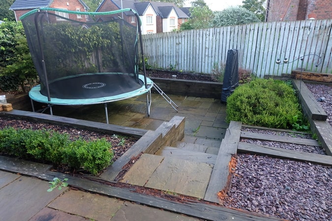A Cockermouth town garden split between levels was looking tired. Sleeper retaining walls needed replacing and drainage was an issue causing boggy ground. A modern/contemporary theme was required with space for dining/entertaining.