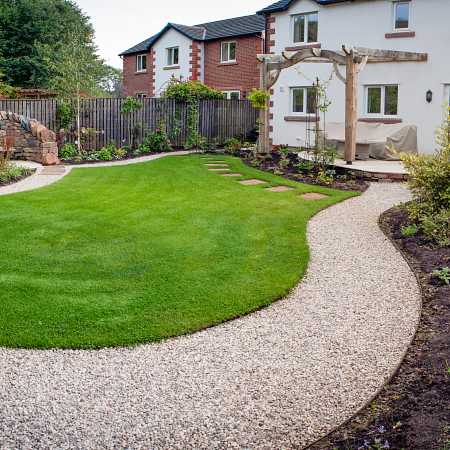 Large planting areas were installed creating a welcoming environment for birds and insects. A path leads you around the garden, passing spots to relax in the shape of a sheltered seating area and a summer house. Drainage was installed to solve issues with boggy ground.