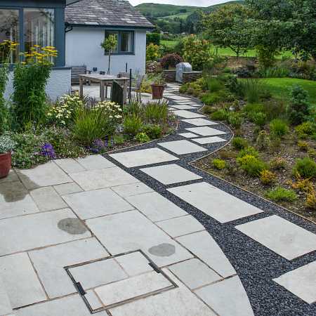 A dining area with a kitchen garden was constructed near the house, with paths leading off to other areas of the garden to enjoy. The end product is a modern looking garden with details here and there to make it a haven to all wildlife.